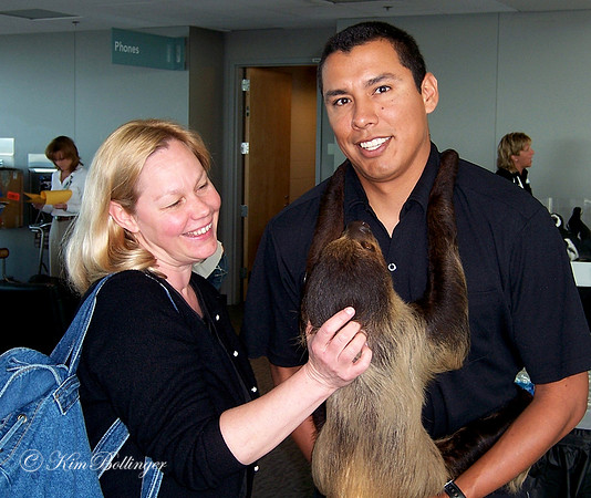 Kim and an animal keeper holding a sloth